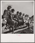 Spectators at paddock fence between races. Warrenton, Virginia.