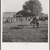 Spectators at paddock fence between races. Warrenton, Virginia.