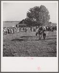 Spectators at paddock fence between races. Warrenton, Virginia.