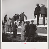 Spectators at paddock fence between races. Warrenton, Virginia.