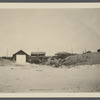 View. Hither Plains, Life Guard boat, Smith Cottage in center, Parsons Cottage on right. Montauk, East Hampton