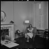 Unidentified woman seated with a cat