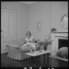 Unidentified woman seated with a magazine