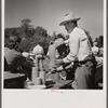 Waiting in line for barbecued beef at the stockmen's picnic and barbecue. Spear's Siding, Wyola, Montana.