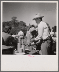 Waiting in line for barbecued beef at the stockmen's picnic and barbecue. Spear's Siding, Wyola, Montana.