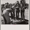 Waiting in line for barbecued beef at the stockmen's picnic and barbecue. Spear's Siding, Wyola, Montana.