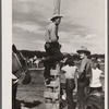 Cowboys and spectators at Ashland rodeo, Montana.