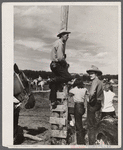 Cowboys and spectators at Ashland rodeo, Montana.