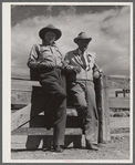 "Doc" Conway, rancher from Craig, Colorado, talking to Beckman, commission merchant from Denver stockyards, by livestock pens in Craig, Colorado.