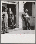 County judge with mortician and workman in front of mortuary. Main street of Leadville, old mining town, Colorado.