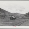 Cabins on ranch. Mist and clouds over mountains before an early blizzard.