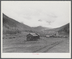 Cabins on ranch. Mist and clouds over mountains before an early blizzard.