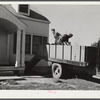 Harvey Renninger with helper, Tony Ringler, delivering coal to one of the families of Two River Non-Stock Cooperative, a FSA (Farm Security Administration) co-op at Waterloo, Nebraska.