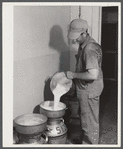 Don Shinaut, in charge of dairy enterprise, pouring milk into cans at Two River Non-Stock Cooperative, Waterloo, Nebraska. This is a FSA (Farm Security Administration) coop (see 59454-D).