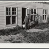 Arnold Sobers, poultry helper, with baskets of eggs outside poultry house. Two Rivers Non-Stock Cooperative, Waterloo, Nebraska. Eggs are marketed through large cafes, restaurants, and eating houses, various hospitals and institutions in Omaha.