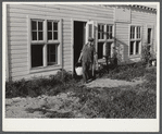 Arnold Sobers, poultry helper, with baskets of eggs outside poultry house. Two Rivers Non-Stock Cooperative, Waterloo, Nebraska. Eggs are marketed through large cafes, restaurants, and eating houses, various hospitals and institutions in Omaha.