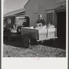 Henry Harringer, in charge of purchasing and marketing enterprise, delivering ground feed at dairy barn. Two Rivers Non-Stock Cooperative Company, FSA (Farm Security Administration) co-op. Waterloo, Nebraska.