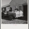 Henry Harringer, in charge of purchasing and marketing enterprise, delivering ground feed at dairy barn. Two Rivers Non-Stock Cooperative Company, FSA (Farm Security Administration) co-op. Waterloo, Nebraska.