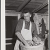 Mrs. Woods, member of board of directors of Tri-County Farmers Co-op Market at Du Bois, Pennsylvania. Wrapping buns at the market.