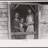 Mrs. Patrick Dumond and two of her children at back door of their home in Lille, Maine. French-Canadian potato farmer and FSA (Farm Security Administration) clients.