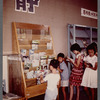 Children standing at bookrack