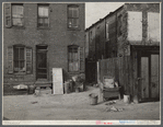Negro slums. Alexander Court between K and L Streets N.W. A woman and her two children lived in four small rooms eight and one half years and pay twelve fifty a month for rent. Water and privy in the yard. Rents in nearby houses have gone up but not here.