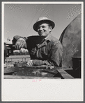 Elmer Womack, derrick man from Fairfax, Oklahoma overhauling mud hog where oil well is being drilled in Goodrich field of Continental oil company. Valley Center oil field near Wichita, Kansas. He has been working in Kansas fields about six years, used to