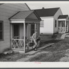 Fred B. Williams from Savannah, Georgia, a safety engineer at the powder plant, leaving his home at 803 9th Steet. Sunset Village, Radford, Virginia. FSA (Farm Security Administration) project for defense workers.