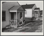Fred B. Williams from Savannah, Georgia, a safety engineer at the powder plant, leaving his home at 803 9th Steet. Sunset Village, Radford, Virginia. FSA (Farm Security Administration) project for defense workers.