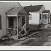 Fred B. Williams from Savannah, Georgia, a safety engineer at the powder plant, leaving his home at 803 9th Steet. Sunset Village, Radford, Virginia. FSA (Farm Security Administration) project for defense workers.