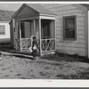 Boy delivering newspapers to defense workers homes in Sunset Village. FSA (Farm Security Administration) project. Radford, Virginia.