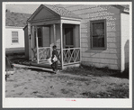 Boy delivering newspapers to defense workers homes in Sunset Village. FSA (Farm Security Administration) project. Radford, Virginia.