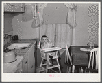 Mary K. Ratcliff, daughter of defense worker, in the kitchen of their home. Sunset Village, FSA (Farm Security Administration) project. Radford, Virginia.