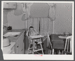 Mary K. Ratcliff, daughter of defense worker, in the kitchen of their home. Sunset Village, FSA (Farm Security Administration) project. Radford, Virginia.