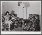 Mrs. Therman N. Ratcliff, defense worker's wife with their daughter, Mary K. Ratcliff, in their living room. Sunset Village, FSA (Farm Security Administration) project, Radford, Virginia.