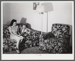 Mrs. Therman N. Ratcliff, defense worker's wife with their daughter, Mary K. Ratcliff, in their living room. Sunset Village, FSA (Farm Security Administration) project, Radford, Virginia.