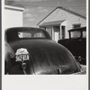 "Help Radford Blow The Hell Out Of Hitler" sign on the back of a defense worker's car in front of his home in Sunset Village, FSA (Farm Security Administration) project. Radford, Virginia.