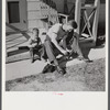 Radford, Virginia. Sunset Village, FSA housing project. Fred B. Williams from Savannah, Georgia, and his son "Buddy" cleaning the car distributer on the porch of his home. 803 9th Street.