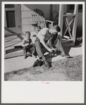 Radford, Virginia. Sunset Village, FSA housing project. Fred B. Williams from Savannah, Georgia, and his son "Buddy" cleaning the car distributer on the porch of his home. 803 9th Street.