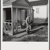 Fred B. Williams from Savannah, Georgia, a safety engineer at the powder plant, leaving his home at 803 9th Street. Sunset Village, Radford, Virginia. FSA (Farm Security Administration) project for defense workers.