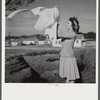 Mrs. Therman N. Ratcliff, wife of defense worker, hanging clothes on the line in back of their home in Sunset Village, FSA project, Radford, Virginia.