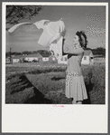 Mrs. Therman N. Ratcliff, wife of defense worker, hanging clothes on the line in back of their home in Sunset Village, FSA project, Radford, Virginia.