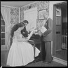 Unidentified people by a piano