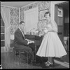 Unidentified people by a piano