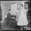 Unidentified people by a piano