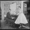 Unidentified people by a piano