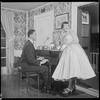Unidentified people by a piano