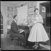 Unidentified people by a piano
