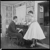 Unidentified people by a piano