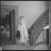 Unidentified woman in gown on staircase